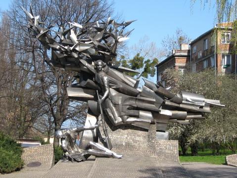 The Monument of the Defenders of the Polish Post Office Pomnik Obrońców Poczty Polskiej The metal sculpture of the monument stands on the square in