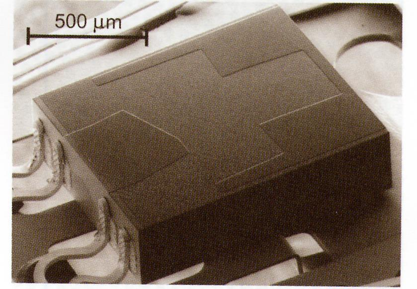 The pico-slider (1.25 1 0.3 mm). SEM image of Pico-slider. Note the four bonds for read/write head.