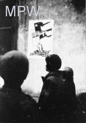 Slika 26: Fotografija plakata»nismo sami«, ki ga je izdelal Stefan Bernaciński iz AL, v avgustu 1944.