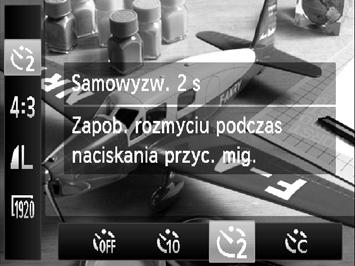 Korzystanie z samowyzwalacza Korzystanie z samowyzwalacza w celu przeciwdziałania poruszeniu zdjęcia Aparat zarejestruje zdjęcie po około 2 sekundach od naciśnięcia przycisku migawki, aby zapobiec