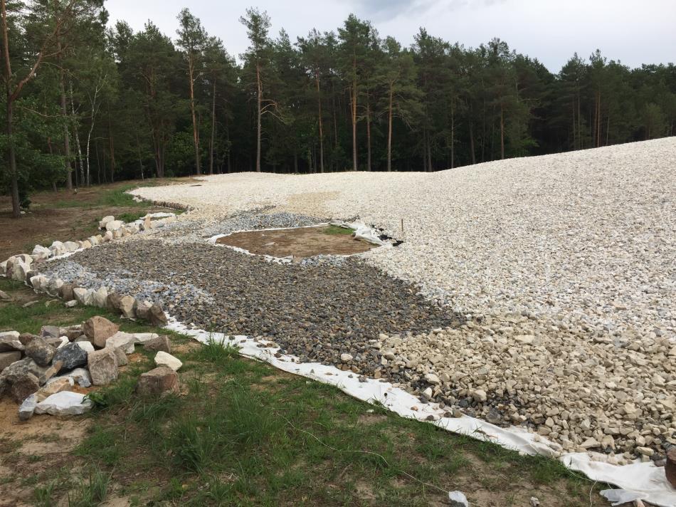 wyznaczył miejsce na północ od kopca pamięci, zlokalizowane w miejscu odkrycia i ekshumacji niespalonych szczątków ludzkich w grobach 12 i 13 (obiekty 2031 i 2032/2033).