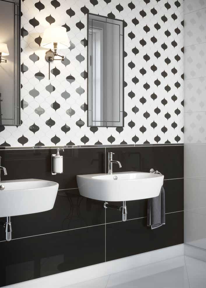 A classic mosaic decorates the wall, the black separates the space together with the white.