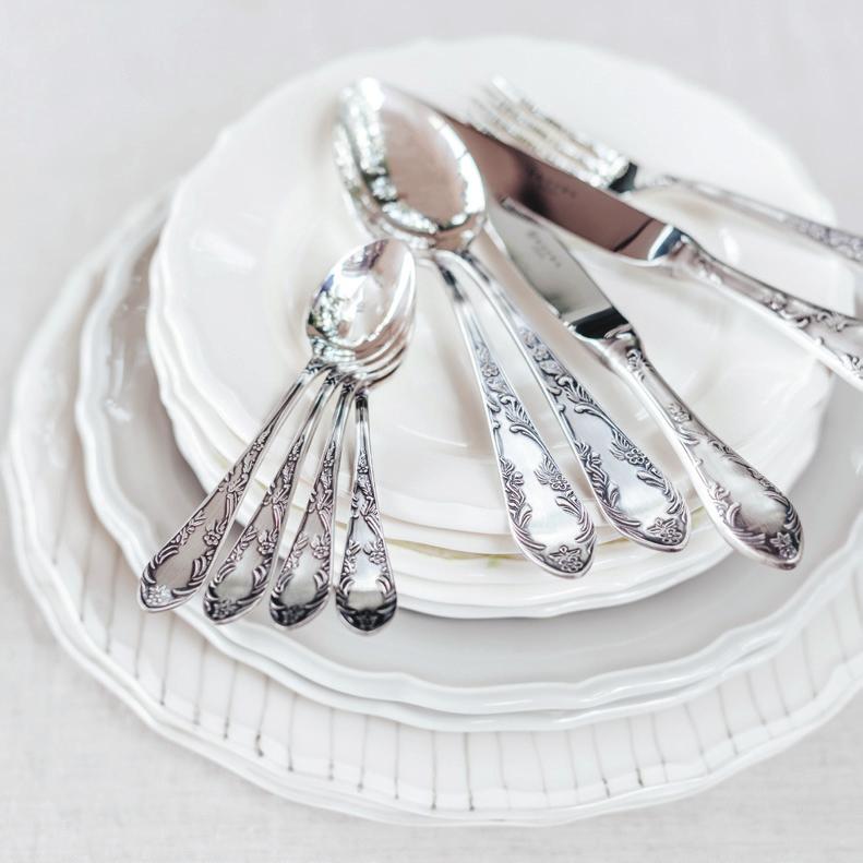 The cutlery features elongated handles with a characteristic twig design. The source of its style comes from the atmosphere of an afternoon dinner and chamber events.