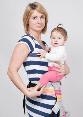 While holding your baby with one hand, reach the chest strap buckle with the other hand and unbuckle it.