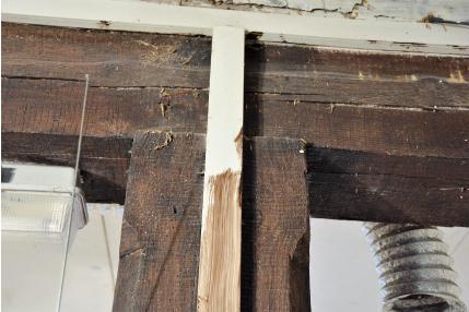 Fotografia nr 106 - Drewniana belka stropu nad parterem podparta słupem.