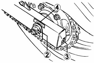 2. Poluzować nakrętkę osi (2). Jeżeli motocykl był wcześniej używany należy uważać na rozgrzane elementy układu wydechowego, których dotknięcie grozi poparzeniem. 3.
