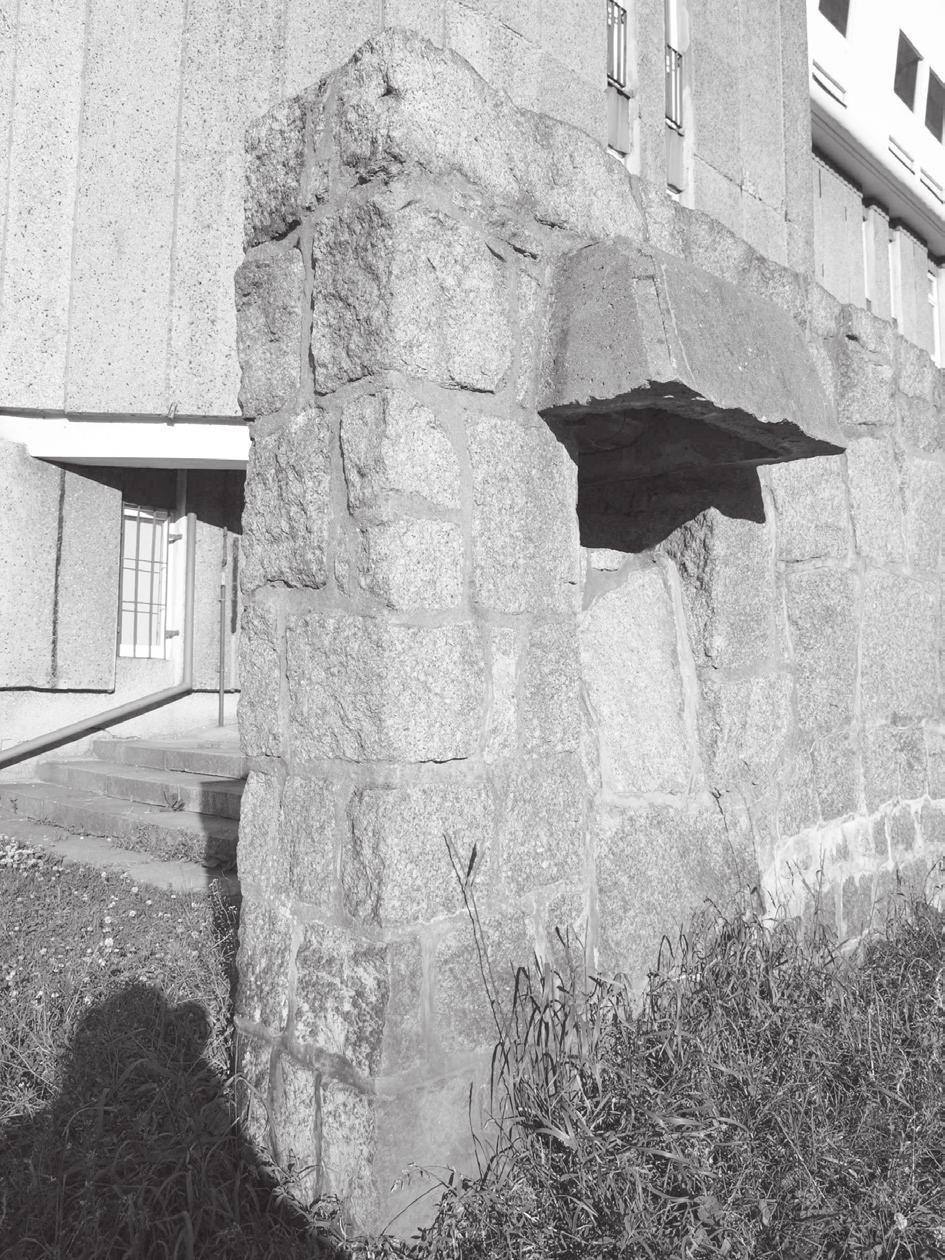 Na archiwalnym zdjęciu obiektu widoczne są grube, prymitywne w wyrazie kamienne mury, ale też elementy wyłamujące się z brutalistycznej stylistyki (duże przeszklenia i cienkie płyty stropodachów).