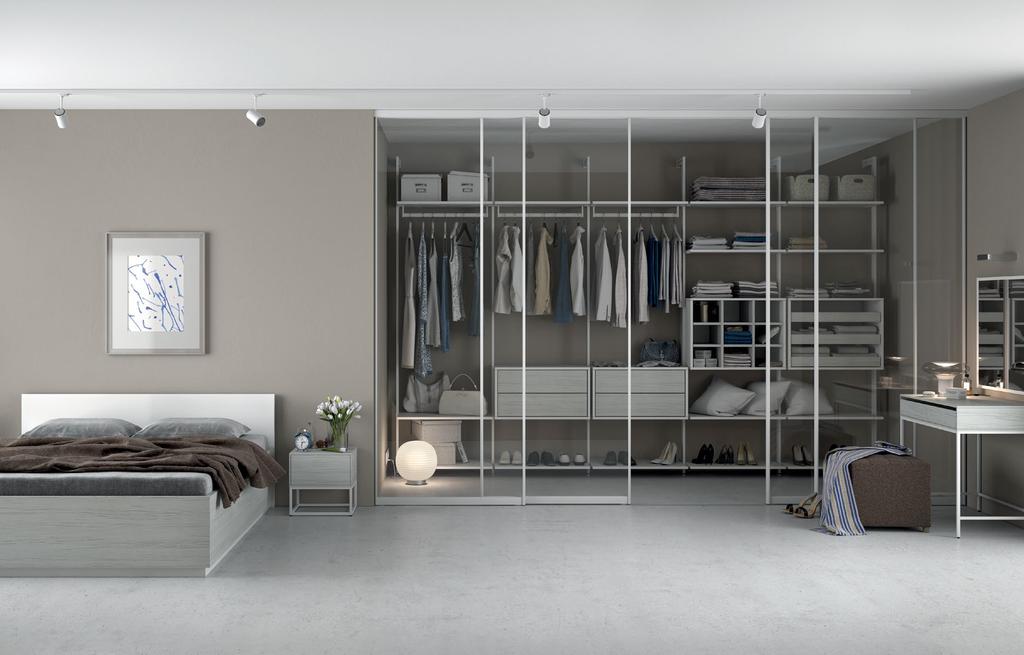MINIMALISTYCZNA Jasna i elegancka garderoba wbudowana w przestrzeń sypialni, zachwycająca stylem i funkcjonalnymi rozwiązaniami.