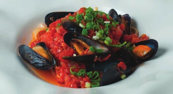 Tomato Basil Mussels served with Pasta 2 lb fresh cultured blue mussels 2 tbsp olive oil 1 4 cup green onions, sliced 1 clove garlic, minced 1 can (19 oz) tomatoes, drained and chopped 1 2 cup dry