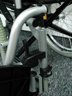 (Illustration 8., 9.) Then rotate it into wheelchair front until it locks ( click sound).