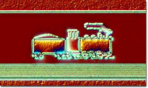 Bob Weppler, designer of the train, has informed us that he placed the locomotive and coal car on the chip at the request of engineer Jerome Saint-Cyr to represent "the little