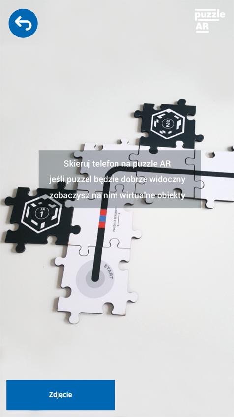 Krok 03 Po kliknięciu START włączy się kamera. Należy skierować jej obiektyw tak, aby wszystkie lub część puzzli wybranych w poprzednim kroku była wyraźnie widoc z na.