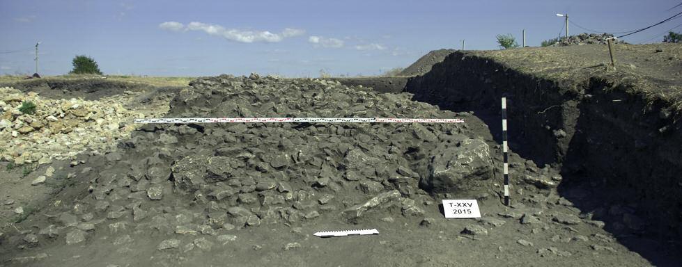 30 m discovered during this season covered nearly the whole area of Square 118 and about next 2 metres in the eastern part of Square 29. The height of the embankment was up to 1.30 m. The rampart was reinforced with the stone coat only from the outer western part of the slope.