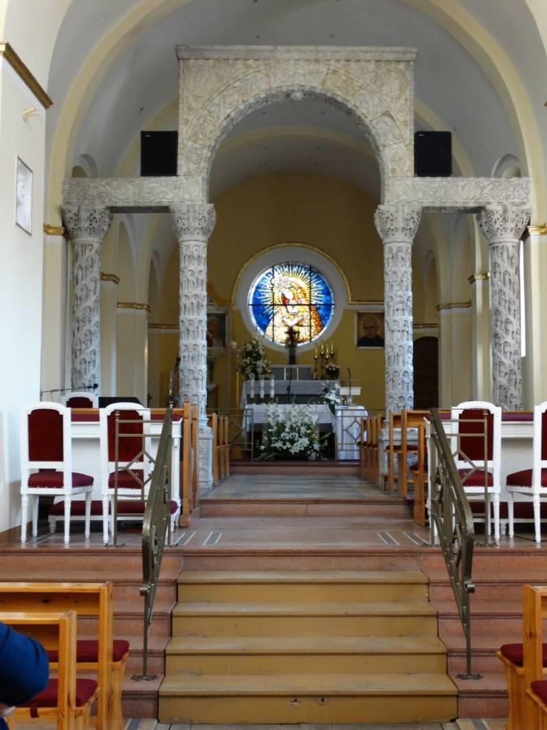 Wnętrze przyozdobione, wspartymi na czterech kolumnach, z trzema łukami z białego marmuru, bogato
