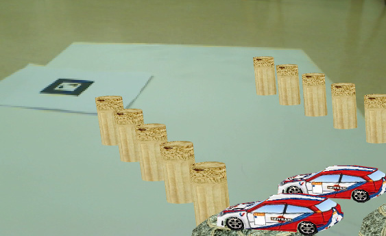 Interfejs użytkownika - Kansei w praktyce 2010 66 Projekt AR Car Game Kolejny projekt pełni rolę rozrywkową zaprojektowana gra pozwala graczom poruszać pojazdy ulokowane na markerach za pomocą