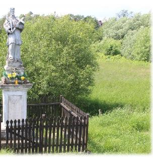 STOLNIKA ÓWCZESNEGO DZIEDZICA A W 1732 ROKU. FIGURKA JEST WYKONANA W STYLU BAROKOWYM, WYKUTA W BIAŁYM PIASKOWCU I USYTUOWANA NA CZWOROBOCZNYM POSTUMENCIE.