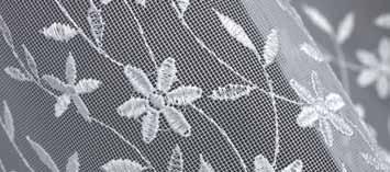 Net curtain embroidered on polyester fabric.