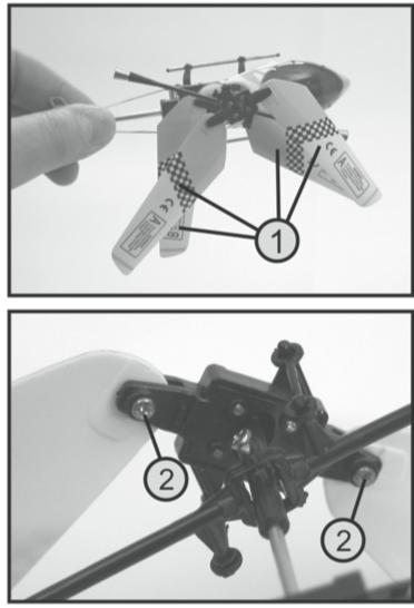 b) Sprawdzanie mocowania płatów wirnika Aby cztery płaty wirnika głównego (1) mogły podczas lotu automatycznie ustawić się względem siebie pod kątem 180, śrubki mocujące płaty (2) wkręcone do płatów