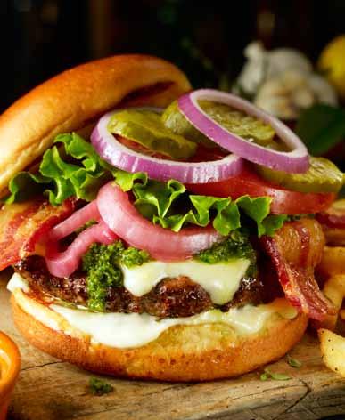 Serwowany z cytrynowym sosem Aioli, plastrami bekonu z pieprzem, cebulą: marynowaną i świeżą, pieczoną papryką jalapeño, sałatą, plastrami pomidora, ogórkiem korniszonym oraz dodatkowym sosem Dragon.