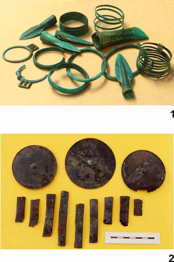 Fig. 5. Szczebrzeszyn, dist.zamość: 1 a big hoard of ornaments, weapons and tools and elements of a horse halter. Photo by H. Szkutnik. Śniatycze, dist.zamość: 2 a hoard of the horse halter ornaments.