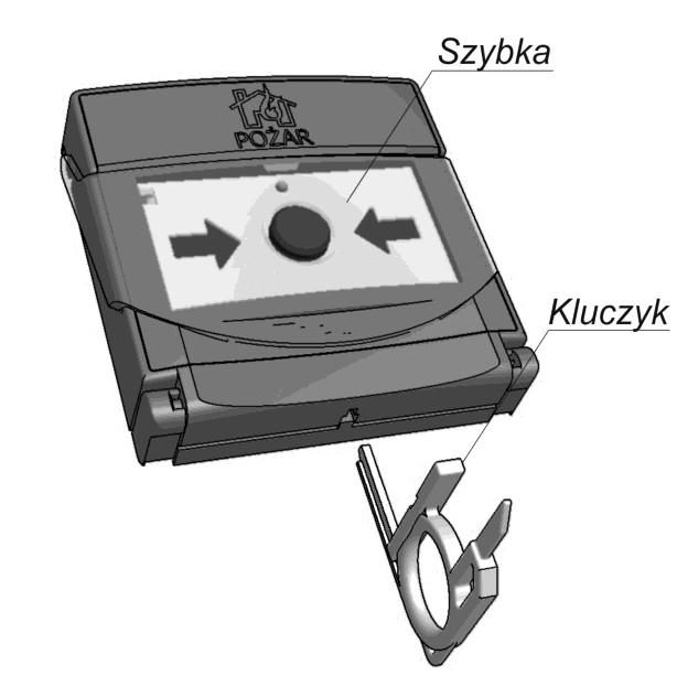 końcówką) aż do skokowej zmiany koloru strzałek na czarny. Po wyjęciu klucza szybka zostanie zablokowana w normalnej pozycji dozorowania. Rys.