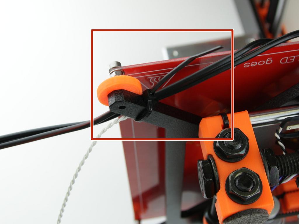 Należy zwrócić uwagę na to, że kable osi X są przeciągnięte między obudową a ramą drukarki w miejscu wycięcia.