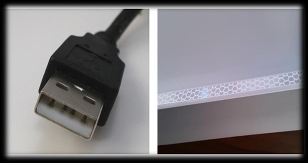 Tablica w srebrnej aluminiowej ramie, wewnątrz aluminiowej ramy naklejona biała taśma refleksyjna. Kabel USB umieszczony w lewym górnym narożniku tablicy.
