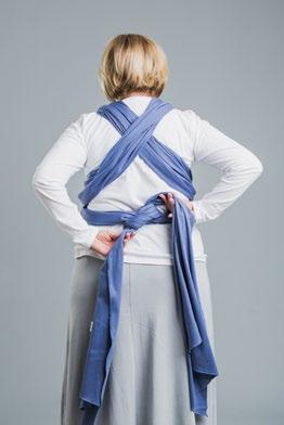 Grab both tails of the wrap and place them under the fabric belt on