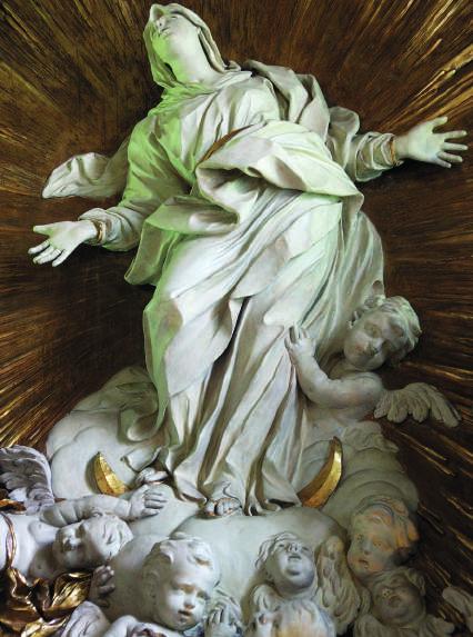 W zwieńczeniu ołtarza ukazano Matkę Boską (il. 11) w konwencji znanej m.in. z krakowskiego kościoła św. Anny łączącej Niepokalane Poczęcie z Wniebowzięciem.