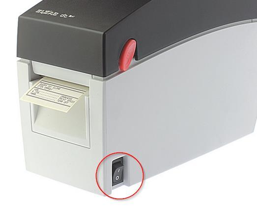 Trzymając przycisk należy uruchomić drukarkę, używając przełącznika z boku.