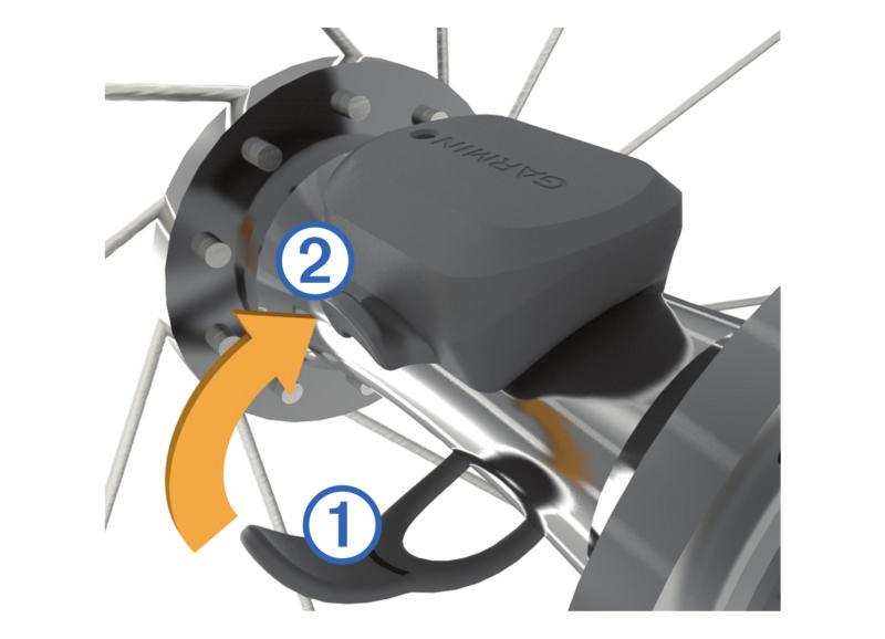 PORADA: Firma Garmin zaleca umieszczenie roweru na stojaku przed rozpoczęciem montażu czujnika. 1 Umieść czujnik prędkości u góry piasty i przytrzymaj go.