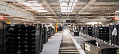 The conveyor circuit runs to the bottom floor, where the order sorting channels have been arranged.