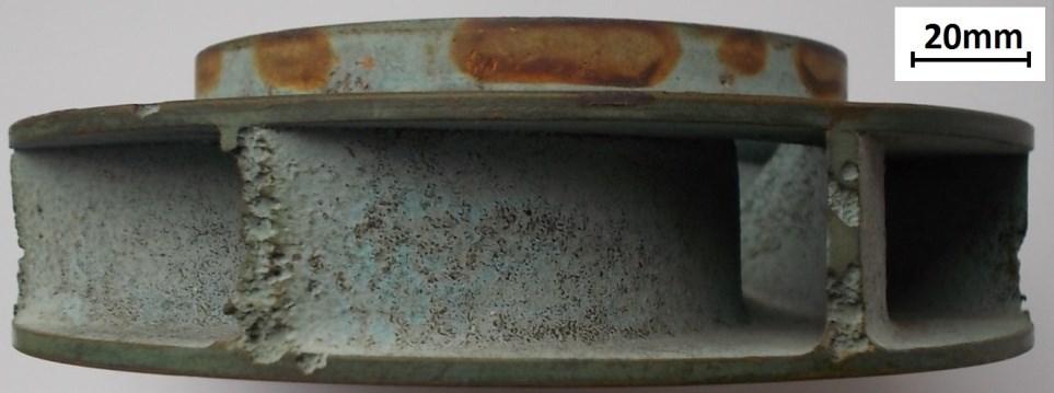 The magnified area shows a typical, rough surface area of cavitation erosion