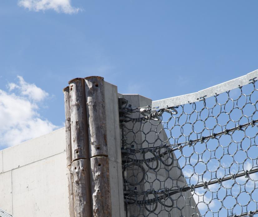 provide extra protection for the concrete pillars, they are covered with tree trunks (easy and cheap in