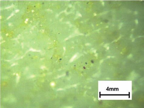Microscopic yellow color image of ceramic tile after laser (60 W) engraftment: a), c) standard conditions, b), d) water environment ne i zróżnicowane pod względem wielkości, co ukazują rysunki 9b,