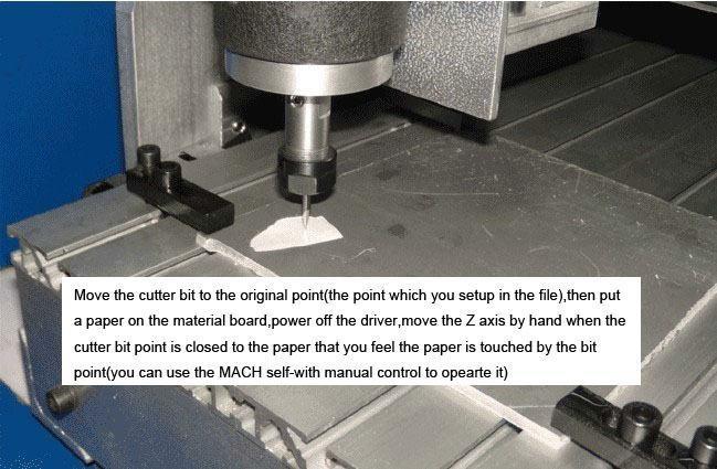 Tekst na zdjęciu: Przesuń frez do punktu początkowego. Następnie, połóż w tym miejscu na materiale kawałek papieru. Teraz ustaw oś "Z" w takim położeniu, aby czubek frezu lekko dotykał papieru.