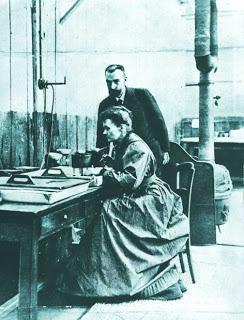 Maria i Pierre Curie w laboratorium (Muzeum Marii Skłodowskiej-Curie w Warszawie) NIEDALEKO PADA JABŁKO.