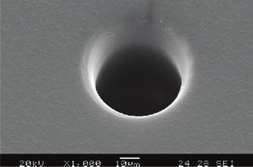192 MECHANIK NR 3/2017 Rys. 6. Mikrootwór przelotowy wykonany drążeniem ECDM w płytce ze szkła (Pyrex Glass) o grubości 150 µm.
