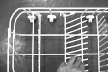 EN To wash bigger items (pots, pans etc.) collapse the plate holders in the lower rack (Fig. 11). Fig. 11 Cutlery Insert the cutlery with the handles aiming downwards (Fig. 12a, 12b).