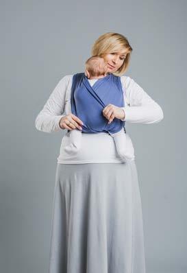Place the baby s legs one by one under the strap of the fabric that you have on your belly.