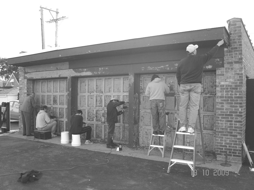 Page Six November 8, 2009 Above, we see Danny s helpers scraping off the paint on the garage doors.