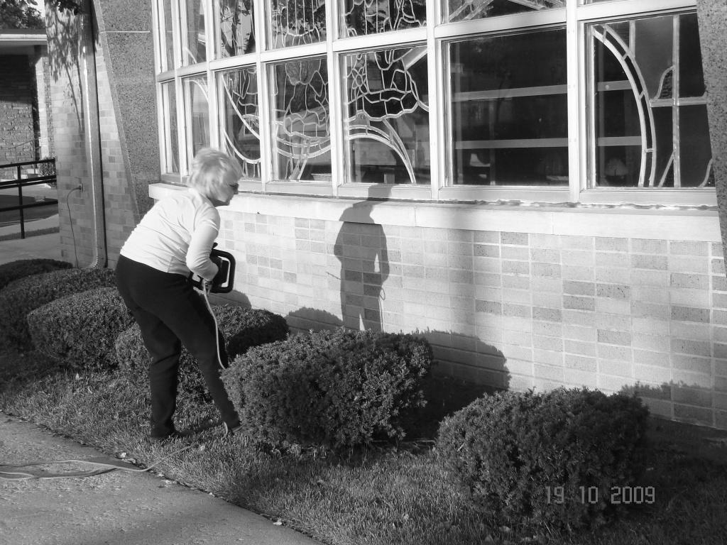 To the left, we see Danny Nierzwicki standing in front of the garage doors, w h o s e beautification he organized and